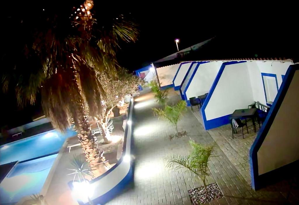 a skateboard ramp next to a pool at night at Nefama Pensao in Ourique