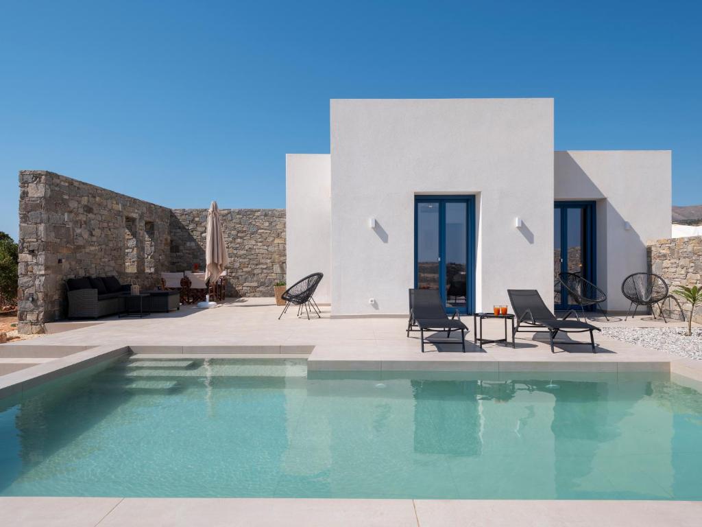 a swimming pool in front of a villa at Cycladic home in Paros in Kampos Paros
