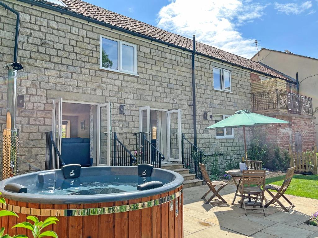 a hot tub in the backyard of a house at The Dairy - Uk50427 in Malton