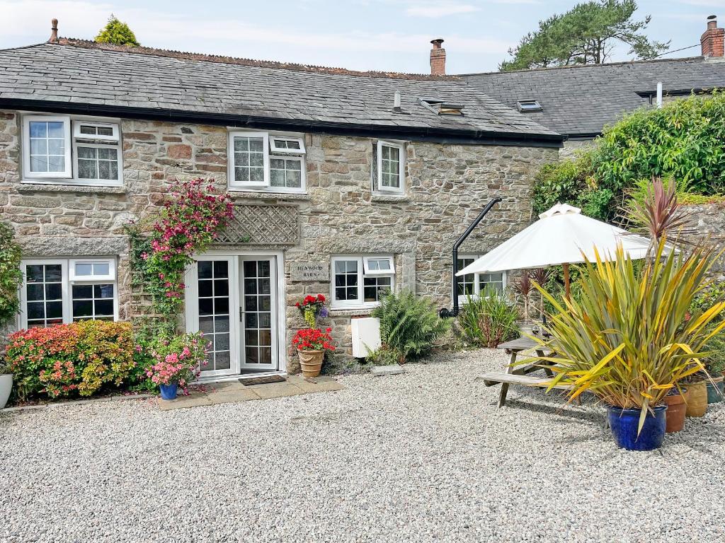 a stone house with a garden in front of it at Henwood Barn - Uk52138 in Liskeard