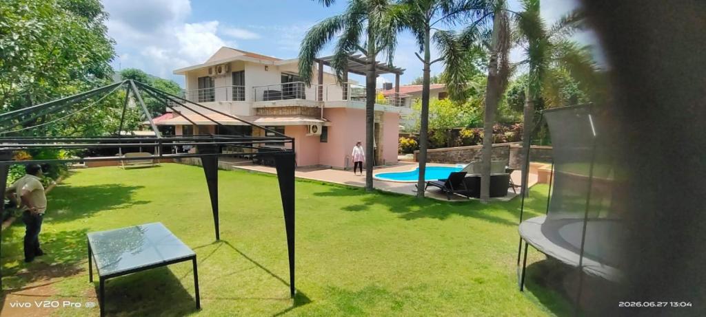 a view of a yard with a house at Holiday villa in Lonavala