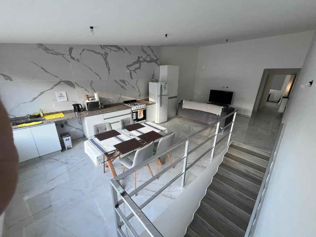 a kitchen with a staircase leading up to a room at Austral Premium in Comodoro Rivadavia