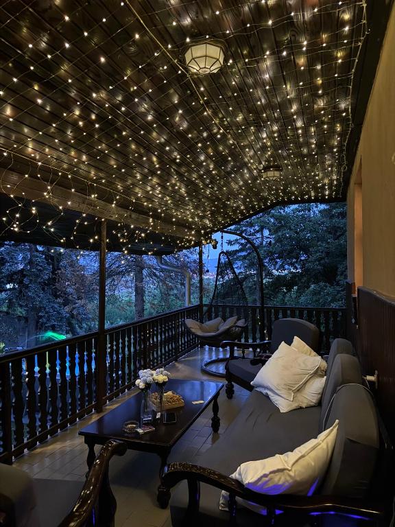 a living room with a couch and a table on a balcony at BrusNica in Gornji Milanovac