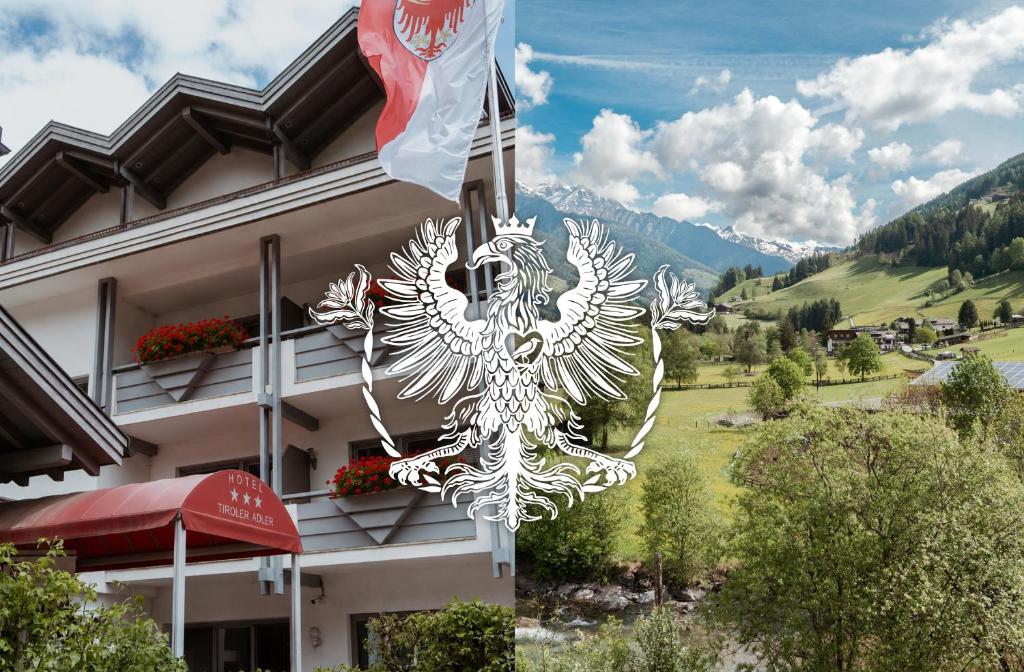 a sign with a flag in front of a building at Hotel Tiroler Adler in Lutago