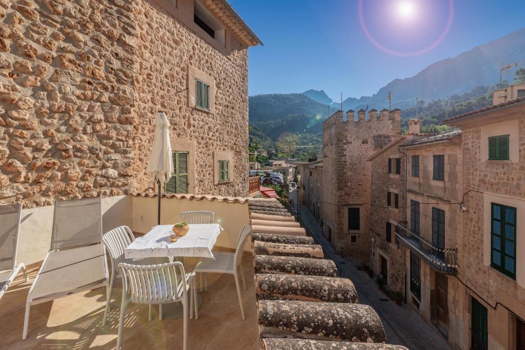 a table and chairs on the balcony of a building at Can Mayol in Fornalutx