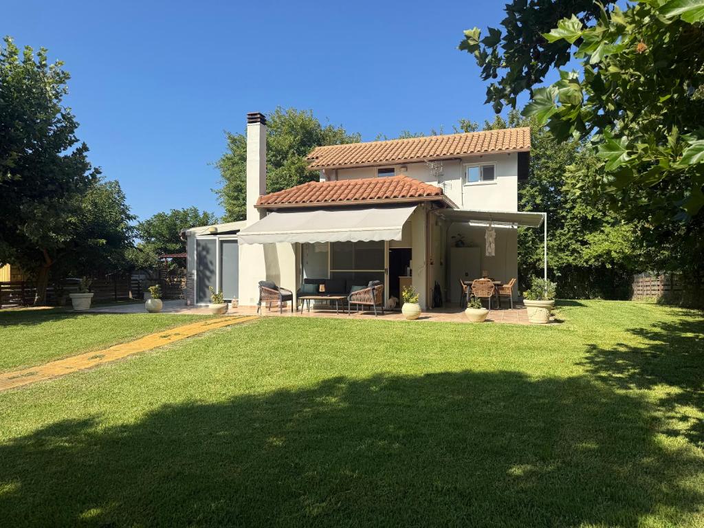 a house with a large yard with green grass at Oasi Loft in Kourouta