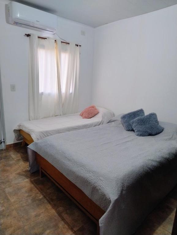two twin beds in a room with a window at Haus Eldorado in Eldorado