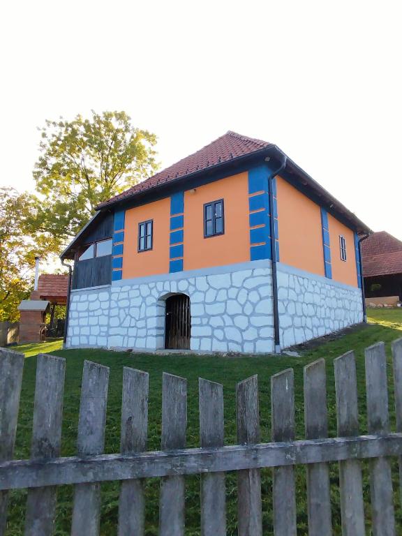 a house that is on top of a field at Domaćinstvo Nikolić-Milicevo Selo in Požega