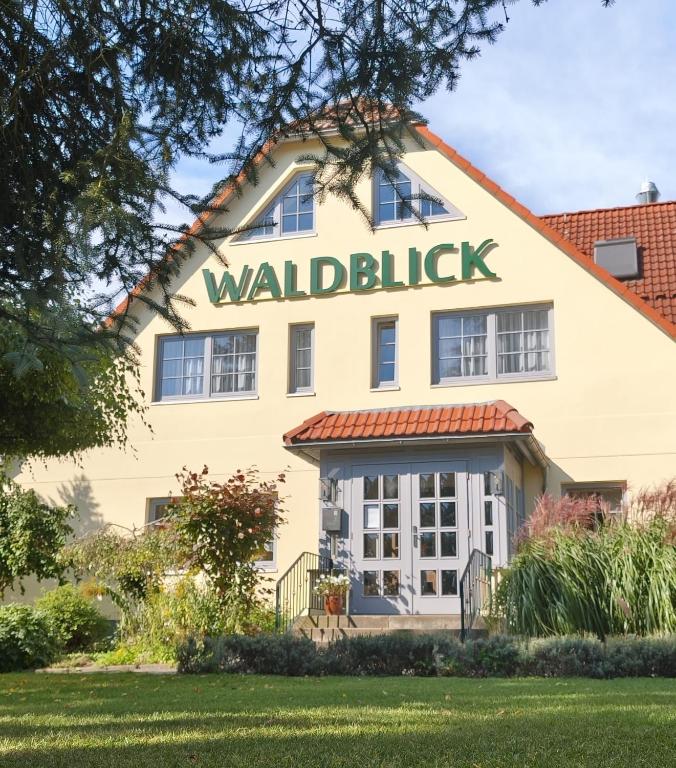 a building with a sign that reads walhalla at Hotel & Restaurant Waldblick in Pulsnitz