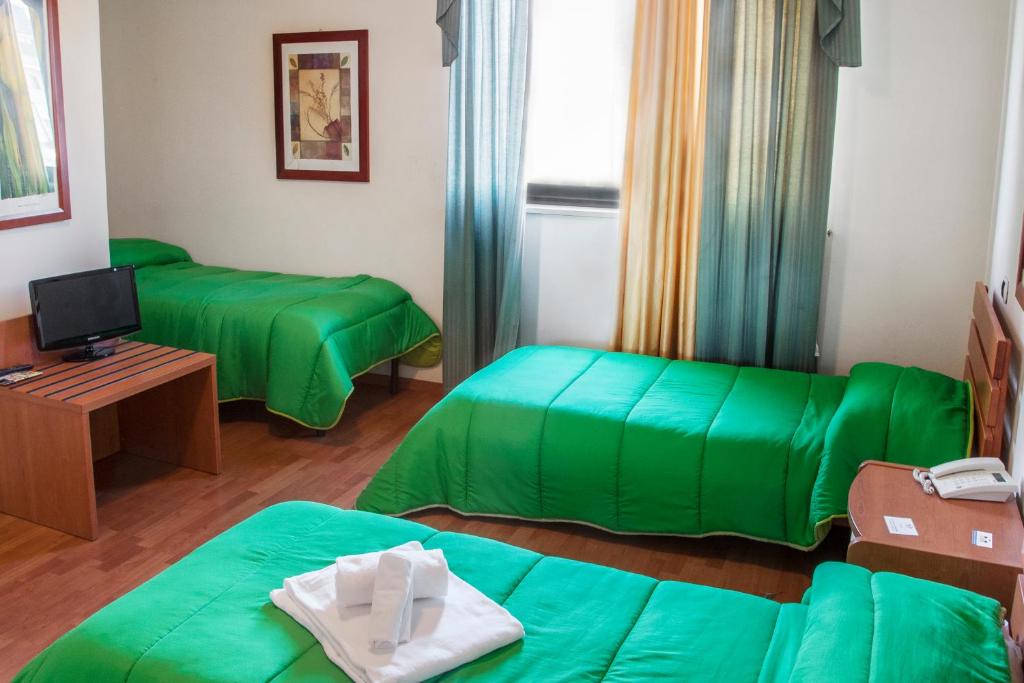 Posteľ alebo postele v izbe v ubytovaní Blu Hotel
