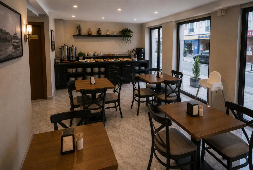 a restaurant with wooden tables and chairs and a counter at T h e V o i d Hotel - Just Steps From Osmanbey Metro Station in Esenyurt