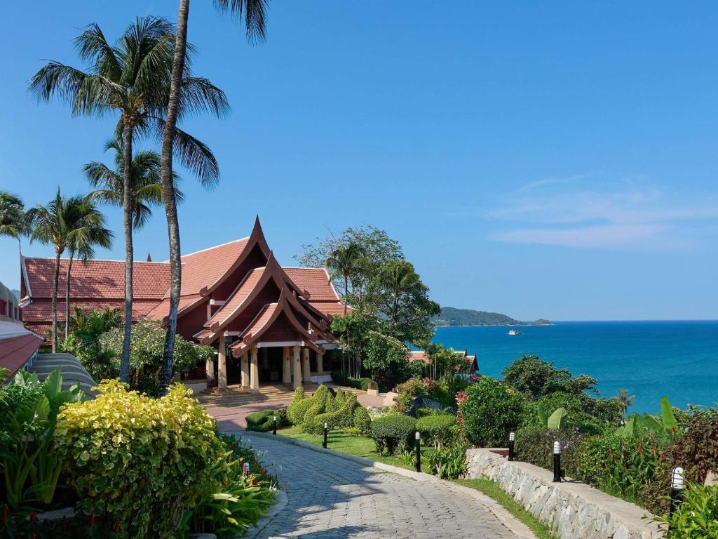 a house on the beach with the ocean in the background at Novotel Phuket Resort in Patong Beach