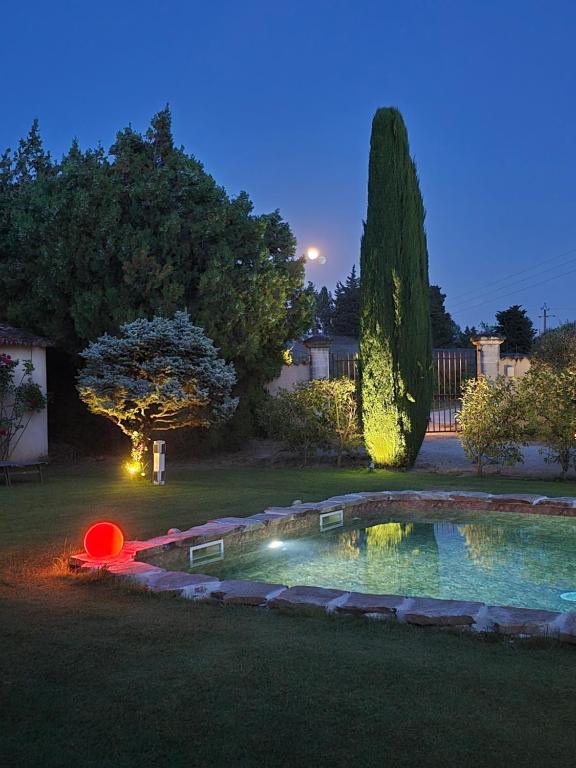 a small pool in a yard at night at Mas Saint Julien in Cavaillon