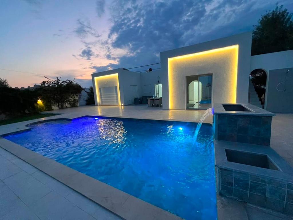 a swimming pool in the backyard of a house at Villa lina in Midoun