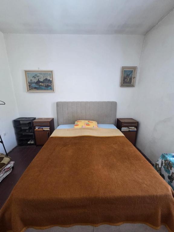 a bedroom with a large bed with a brown blanket at Maki 4 in Radanovići