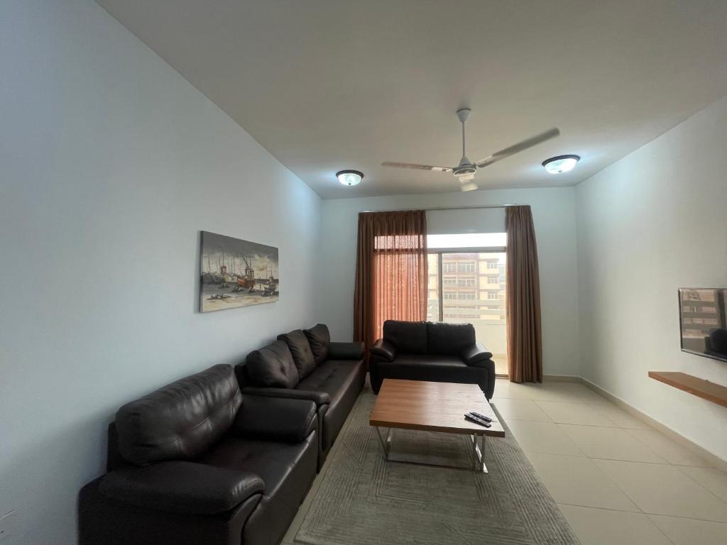 a living room with a couch and a coffee table at Adheeiz beach in Salalah