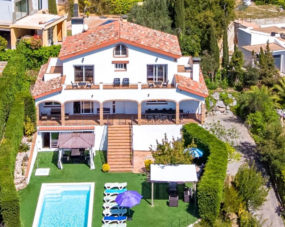 an aerial view of a house with a swimming pool at Villa Panoramic in Santa Susanna