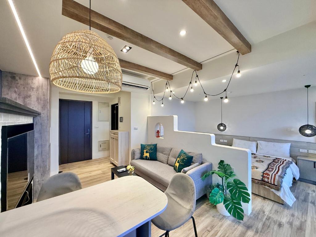 a living room with a couch and a table at 宜蘭頭城A Happy 享私人溫泉及大陽台 全景無邊際泳池 代辦騎馬 賞鯨 遊艇 私廚小吃等遊程 in Toucheng