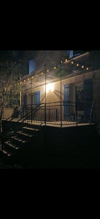 a building with stairs and lights on it at night at Chez lydie et jeff in Laudun
