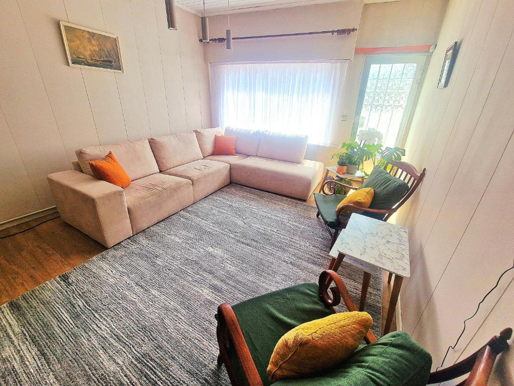 a living room with a couch and some chairs at Tomorrowland in Rumst