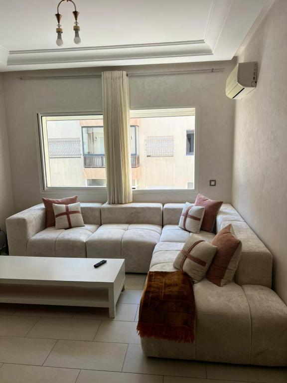 a living room with a couch and a coffee table at Mohammedia Luxury Suite in Mohammedia