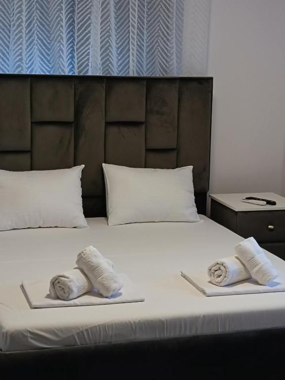 a bed with two towels on top of it at Apartamente 9 Teo in Baile Felix