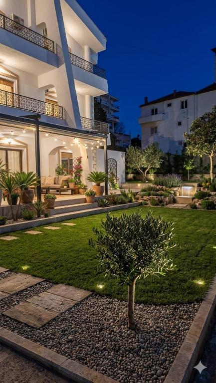 a house with a tree in the middle of a yard at Villa Sofia in Durrës