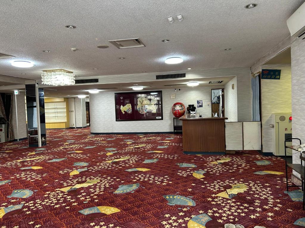 a lobby with a large room with a red carpet at RB hotel in Aizuwakamatsu