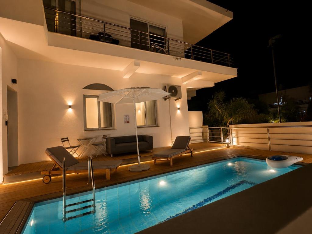 a villa with a swimming pool at night at Villa 56 Luxury apartments in Rhodes Town
