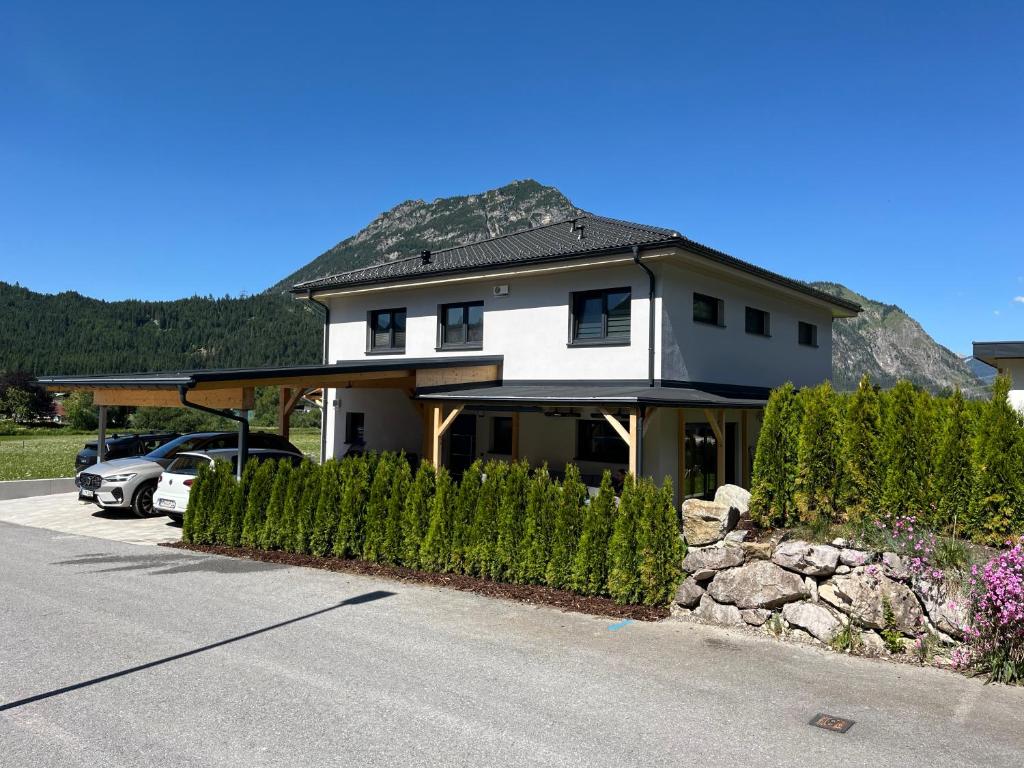 a house with a car parked in a driveway at Ferienwohnung Heiterwang in Heiterwang