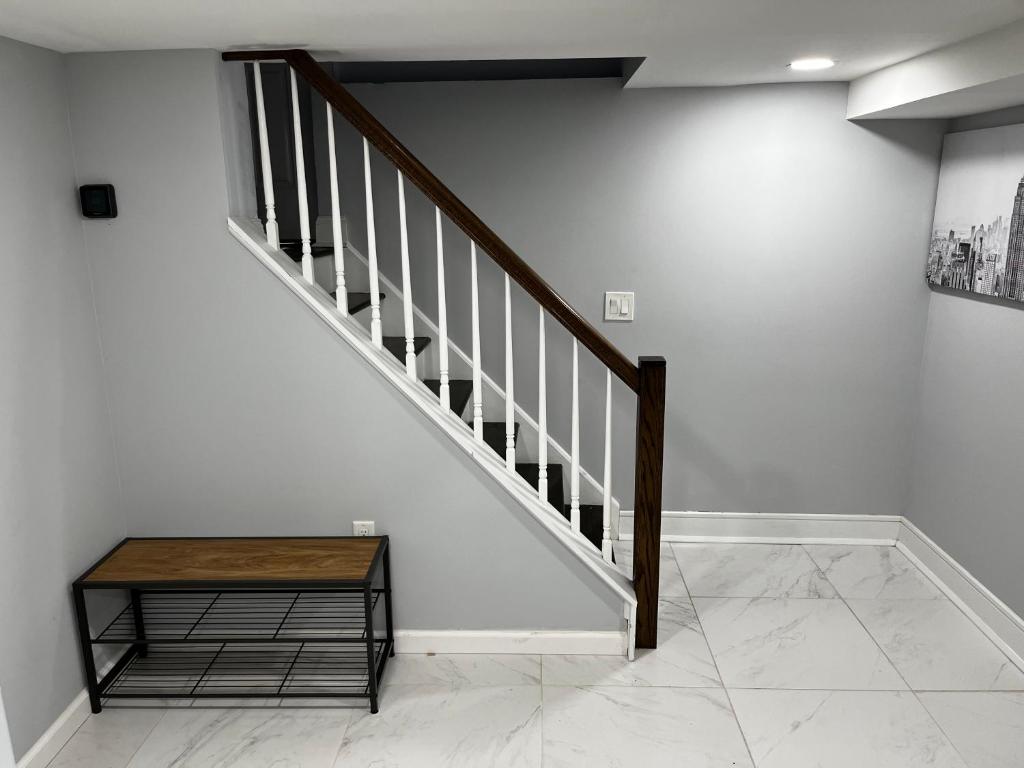 a staircase with a wooden table and a stair case at Lg2NY in Westerleigh