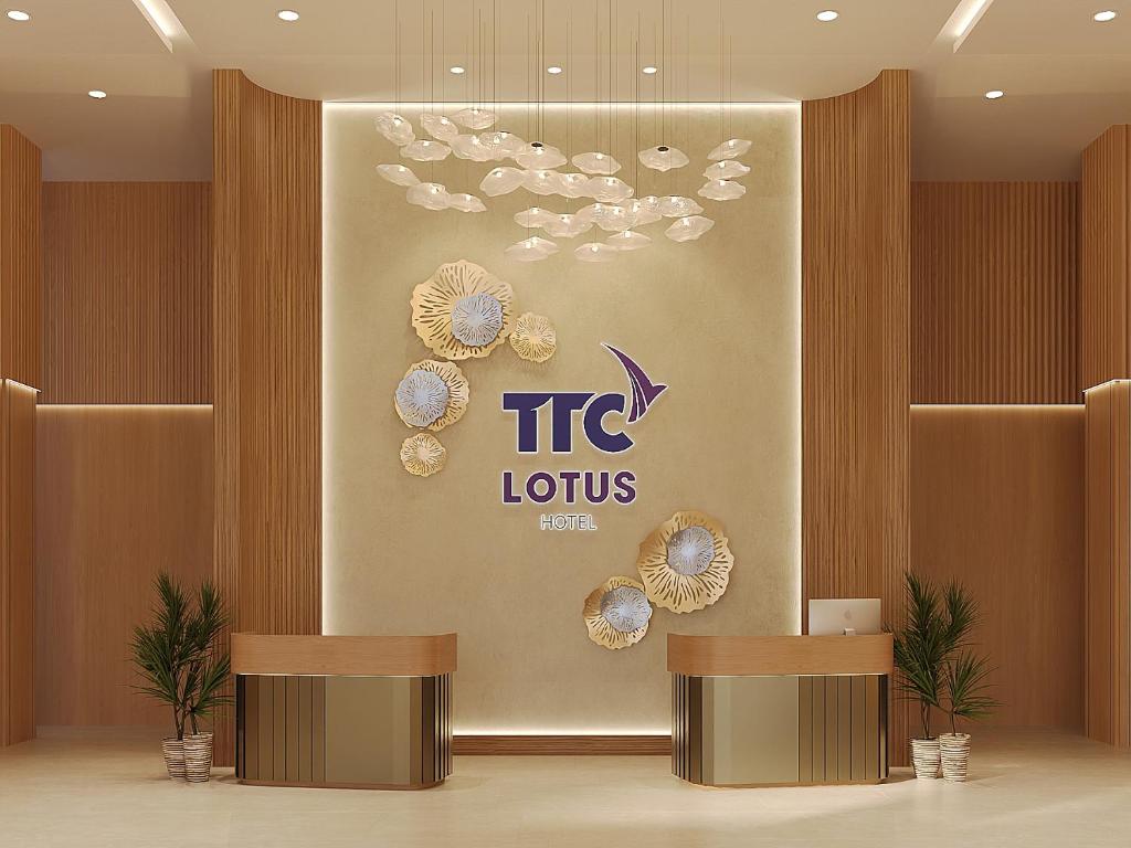 a lobby of a hotel with a sign on the wall at TTC Lotus Hotel in Phú Quốc
