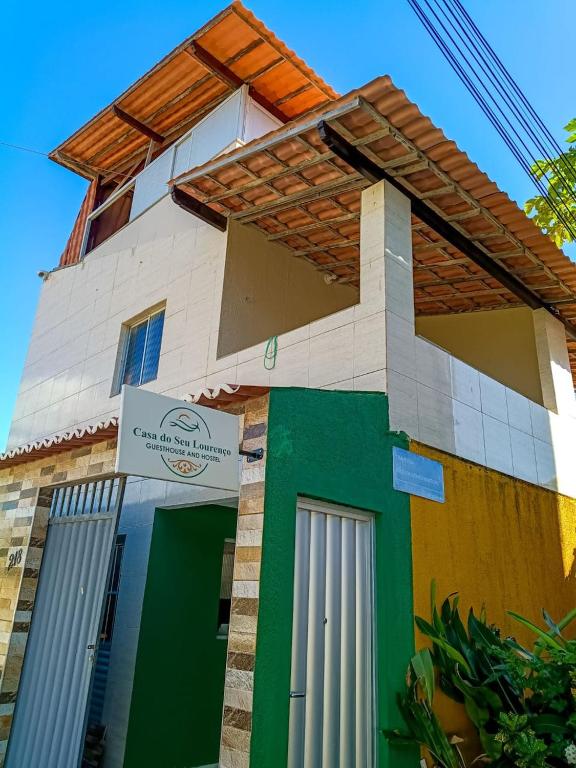 a building with colorful doors and a sign on it at Casa do Seu Lourenço in Beberibe
