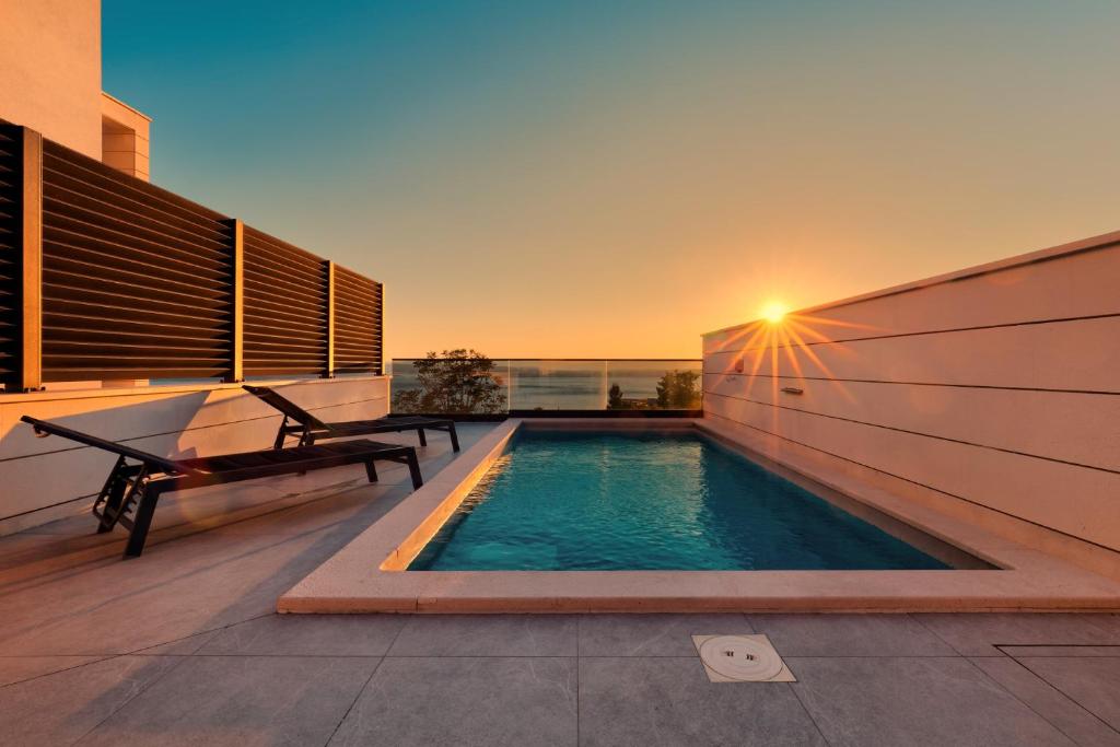 a swimming pool on the roof of a house at Luxurious Sea-View 2BR Apartment with Private Pool-Villa Quadris-Crikvenica in Crikvenica