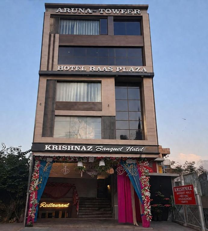 a hotel has a sign on the front of a building at HOTEL RAAS PLAZa in Kānpur