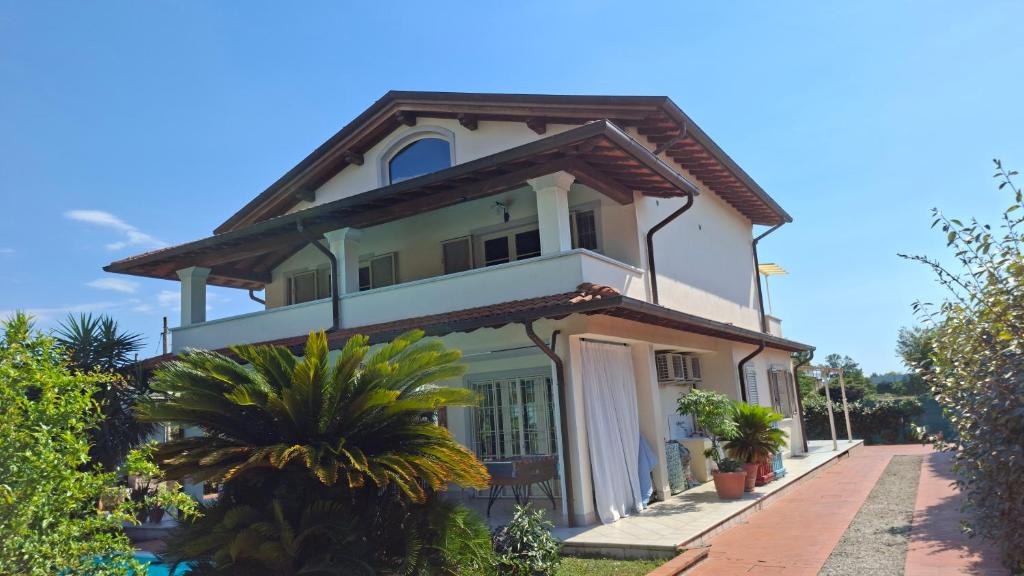 a large white house with plants in front of it at Villa Incanto in Forte dei Marmi