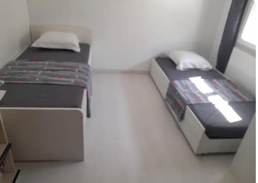 a small bedroom with a bed and a window at Maison de vacance Montpellier in Montpellier