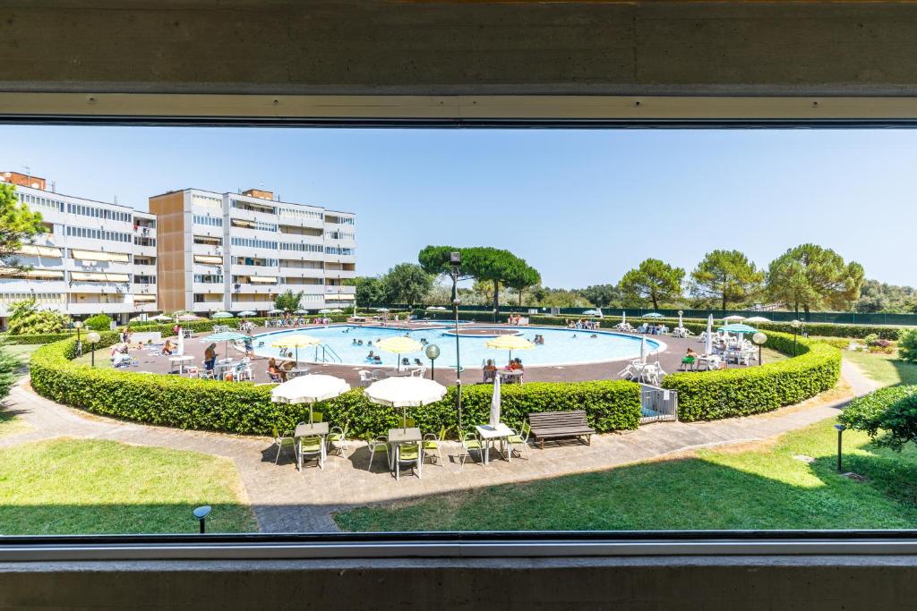 a view of a swimming pool from a window at Piscina Gratis, Pool View Oasis Pool View in Lido Adriano