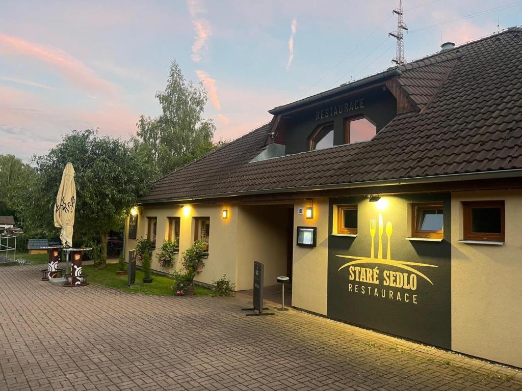 a building with a sign on the side of it at Restaurace Staré Sedlo in Orlík
