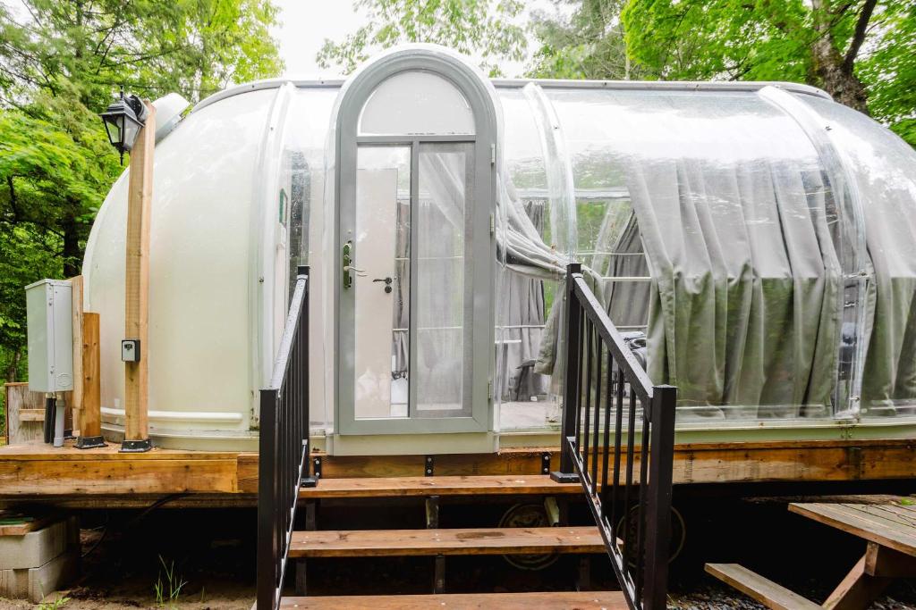 an open door of a camper with a porch at Studio Capsule House in Parry Sound #32 in Parry Sound