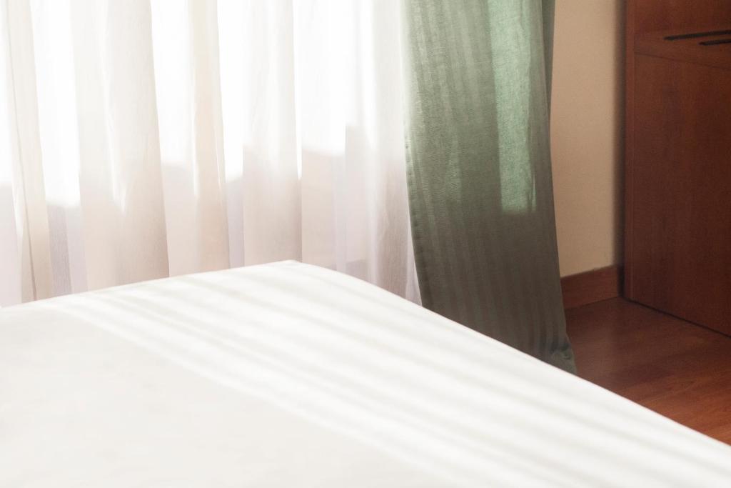 Posteľ alebo postele v izbe v ubytovaní Blu Hotel