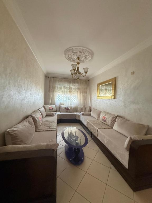 a living room with a couch and a table at Beautiful appartement in Tétouan