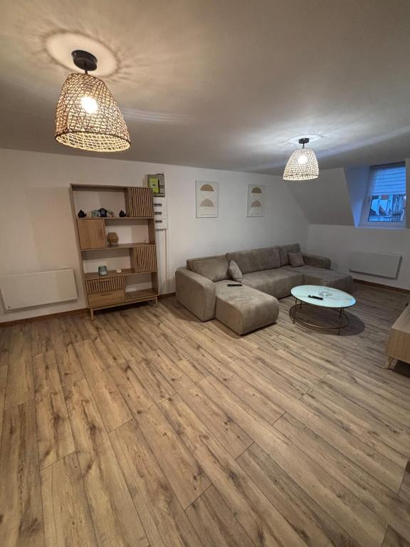 a living room with a couch and a table at Le Cocon in Boulogne-sur-Mer