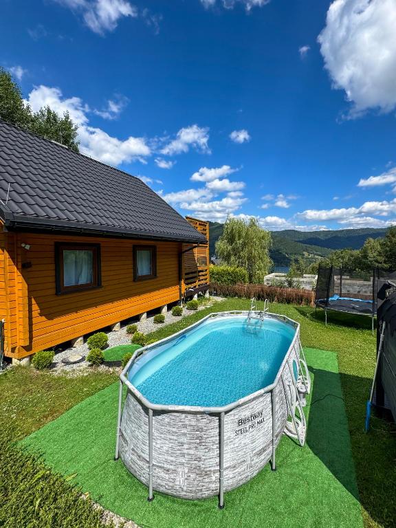 a house with a swimming pool in the yard at Willa Wilk in Międzybrodzie Bialskie