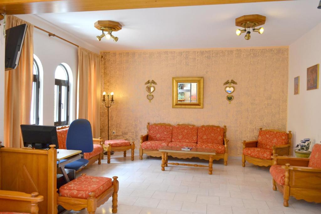 a waiting room with couches and chairs at Amaryllis Hotel in Karpathos
