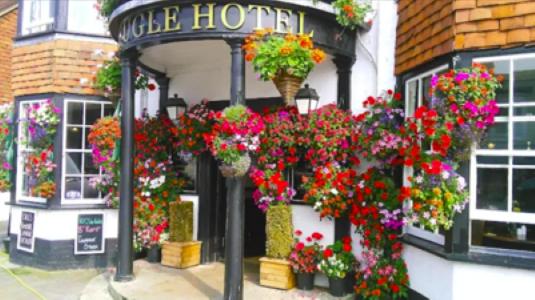 a bunch of flowers on the front of a building at The Bugle Hotel in Titchfield