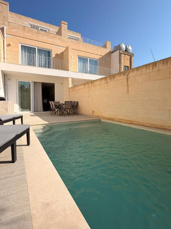 a swimming pool in front of a building at KY Orange Grove in Kerċem