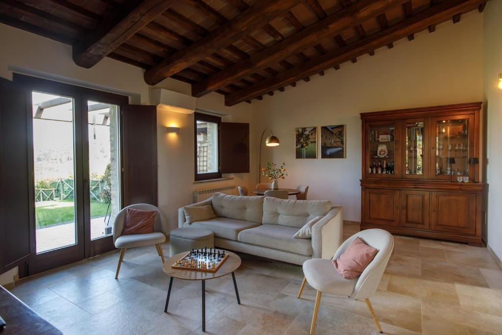a living room with a couch and chairs and a table at Peaceful Umbria views & heated infinity pool in Umbertide