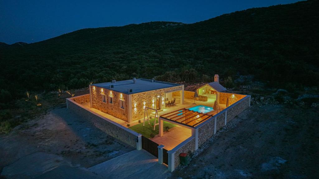 an overhead view of a house with lights on it at Villa Lapidea in Vodice
