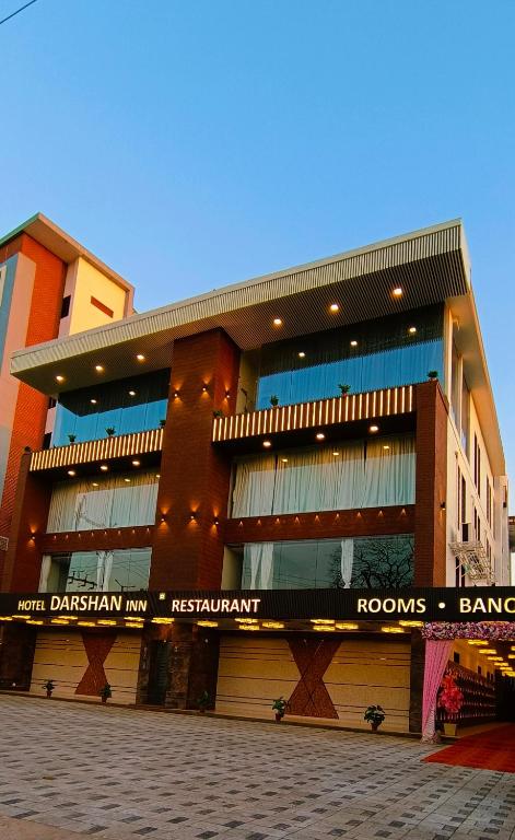 a large building with a street in front of it at Hotel Darshan Inn in Anand